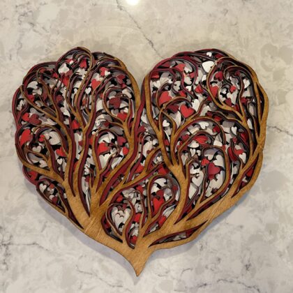 Handcrafted heart-shaped mandala with intricate tree branches and heart leaves. Stained wood front layer with shades of red, white, black, silver, maroon, and rose gold. Ideal for expressing love on Mother's Day or Valentine's.