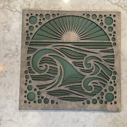 Beach wave cutout art with a matte sea-green base and textured top layer. Features breaking waves and circle bubble cutouts in the corners. Sea-worn appearance, perfect for coastal-themed spaces.